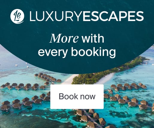 a luxury hotel with a view of the ocean and a boat