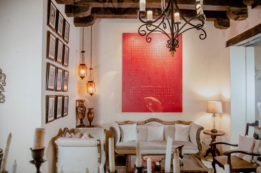 a living room with a red painting on the wall