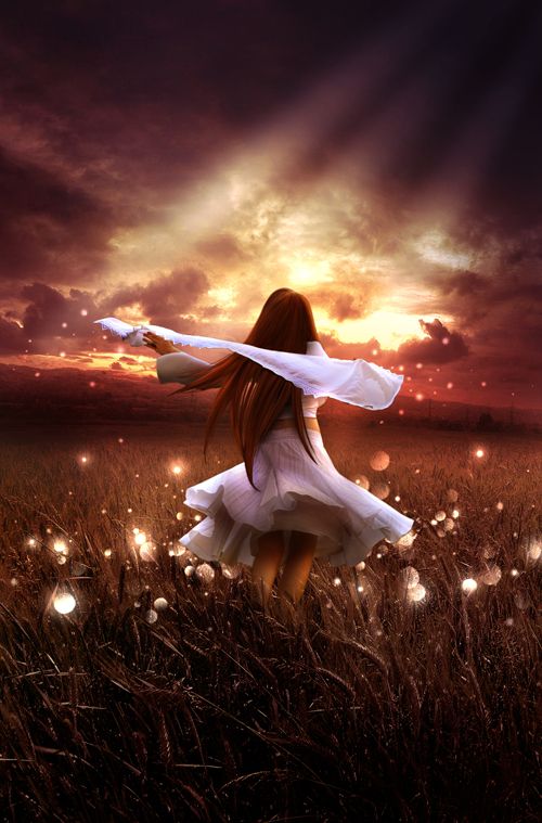 a woman in a white dress standing in a field