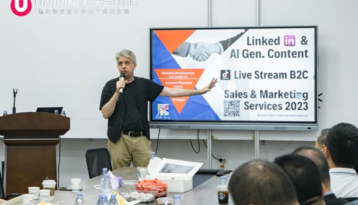 a man standing in front of a large screen