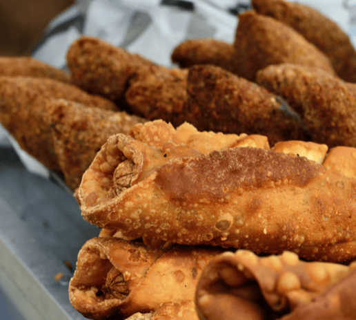 a tray of fried alcapurias and empanadas