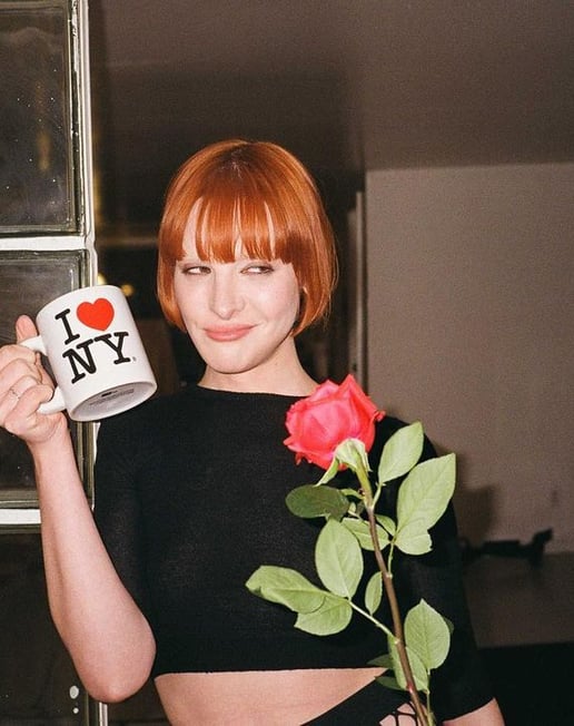 a woman in a crop top and a mug of coffee