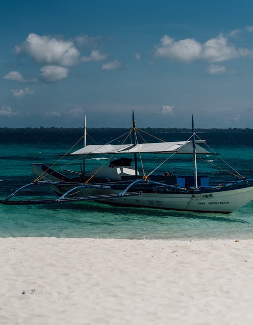 a boat on the beach with a boat in the water