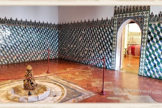 Arabic room in National Palace of Sintra with an indoor fountain surrounded by colorful tiles 