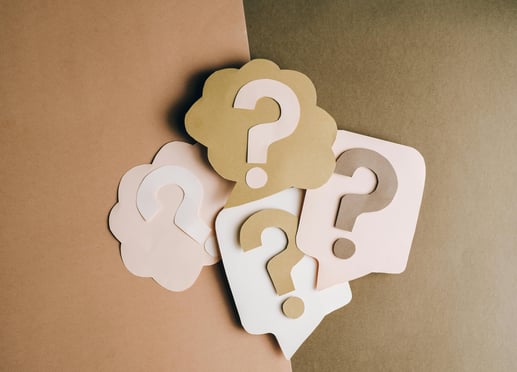 a group of question mark on a brown background