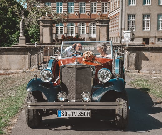 a couple of people in a car with a dog