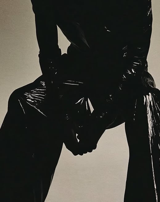 a man in a black leather jacket and black pants