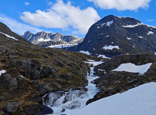 Trollstigen plateau viewpoint with snow and waterfall