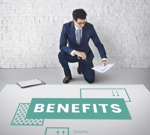 A man is sitting on a knee with a document in hand reading the documents data to check benefits and losses.
