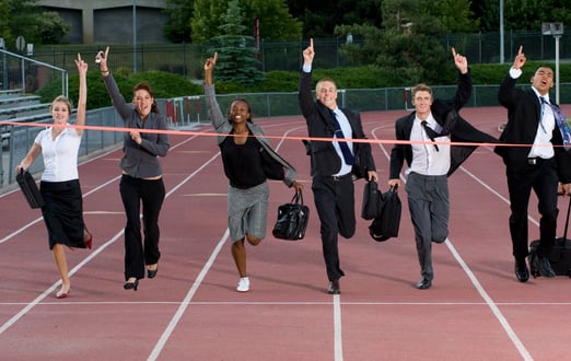 a group of business people running on a track