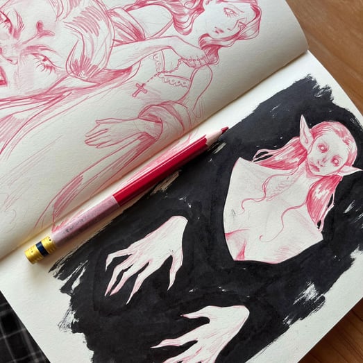 sketchbook page of vampire concepts made with colored pencil and ink