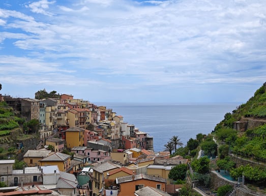 View of Manarola with mountains and sea in background