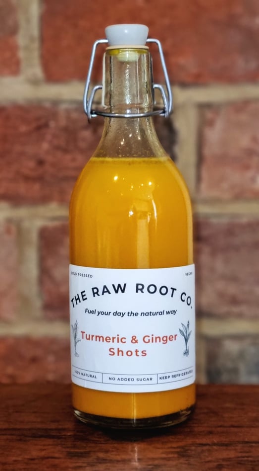 Cold Pressed Turmeric & Ginger health and Wellness Shots in a glass swing top bottle from The Raw Root Co.