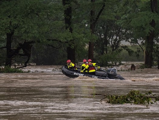 COMFORT, TEXAS – JULY 04: Boerne Search and Rescue teams navigate upstream in an inflatable boat on