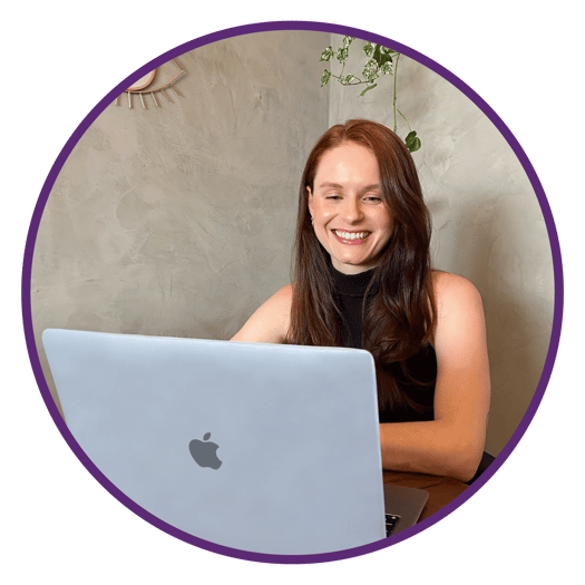 a woman sitting at a table with a laptop computer