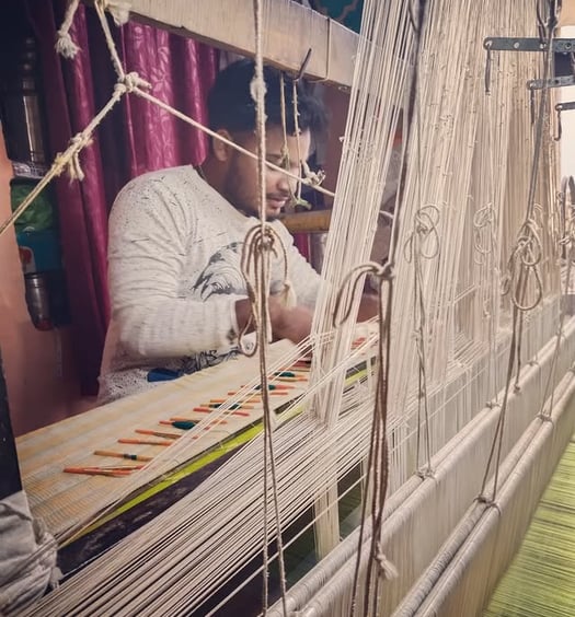 a man is working on a weaving machine