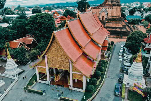 a large building with a red roof and a large building