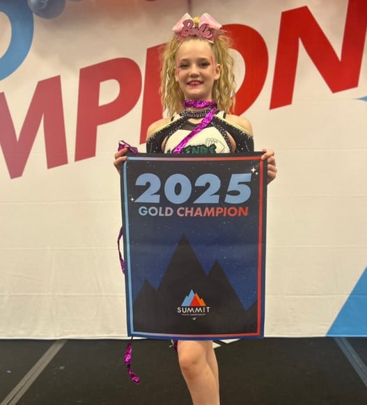 Baylor holding a 2025 championship banner
