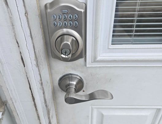 A white door with a keypad lock representing Jack’s Locksmith local keypad door lock services