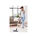 A woman vacuums while listening to an audiobook