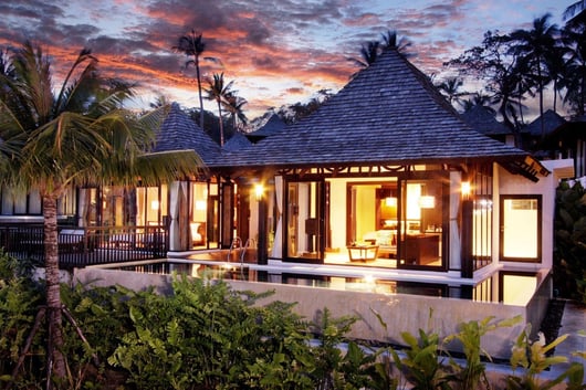 a house with a pool and a view of the ocean from The Vijitt Resort Phuket