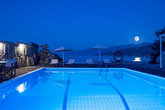 a pool with a moon in the sky Cavos Bay Hotel
