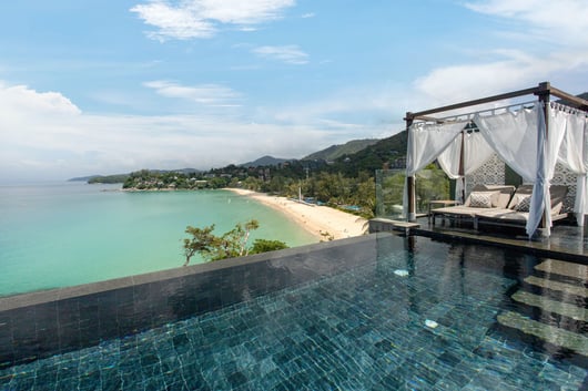 a bed with a canopy bed and a canopy bed from The Shore at Katathani, Phuket Thailand