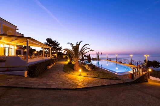 a pool with a view of the ocean Karra's Star Hotel