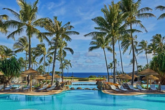 a pool with lounge chairs and umbrellas from The Ritz-Carlton, Kapalua in Hawaii