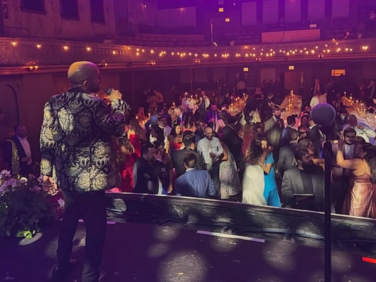 LuxeBand singer performing on stage at a historic venue
