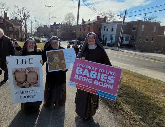 Franciscan Daughters of Mary holding pro-life signs