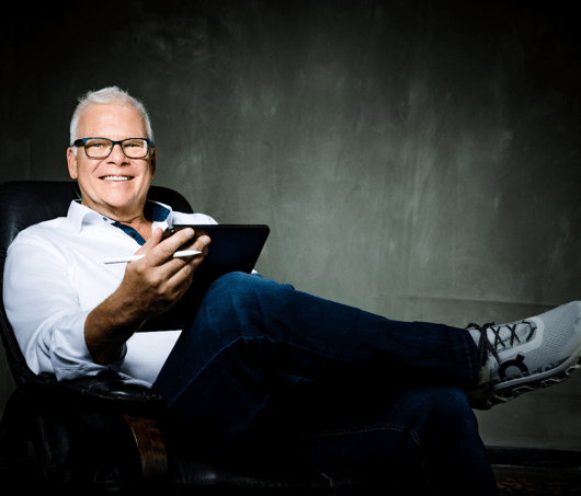 Martin sitting in a chair with a tablet