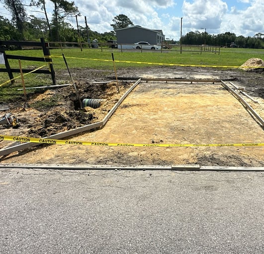 Full concrete driveway installation in Kissimmee, FL with compacted gravel base, rebar reinforcement