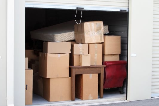 a garage door is open to reveal a lot of boxes of boxes