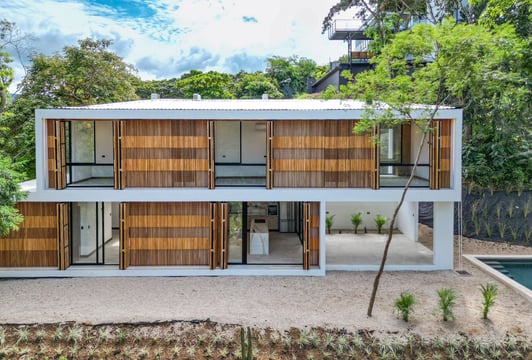 a modern house with a wooden deck and a pool