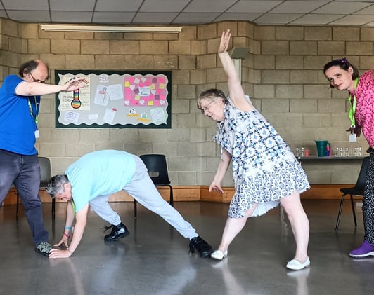 A group of people performing stretched movements