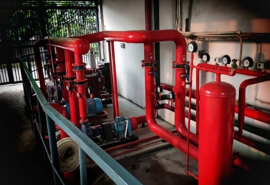 a red fire hydrant with pipes maintenance