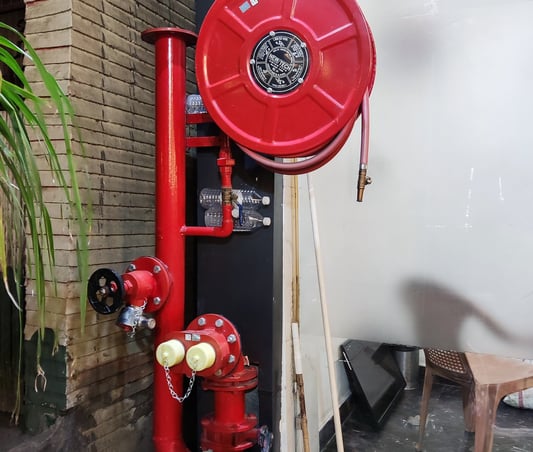 a red fire hydrant sitting on a workplace