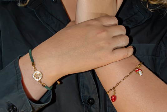 a woman with a black shirt and bracelets