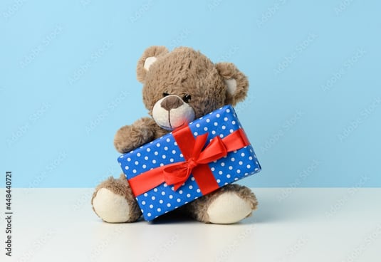 stuffed bear holding gift
