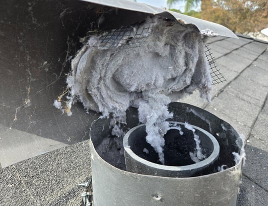 A dryer duct with a screen full of lint