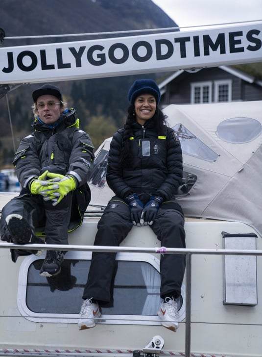 two people sitting on a boat and smiling happy | Jolly Good Times Sailing in Norway