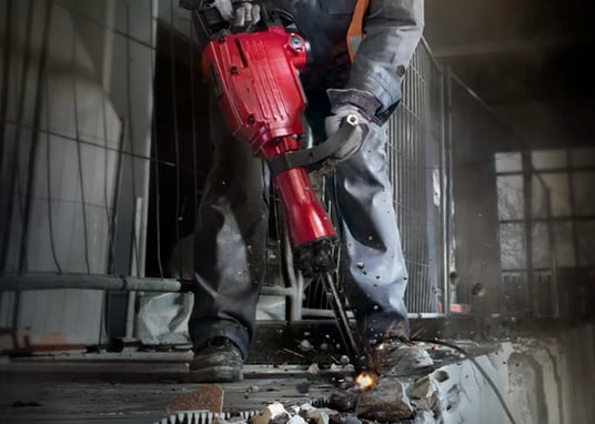 a man in a safety vest and a red helmet