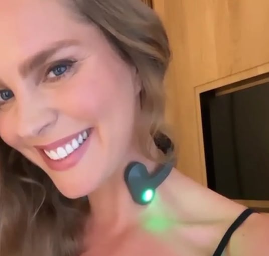 a woman with a green light up in the dark
