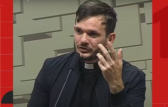 a priest in a black jacket and a priest in a black shirt