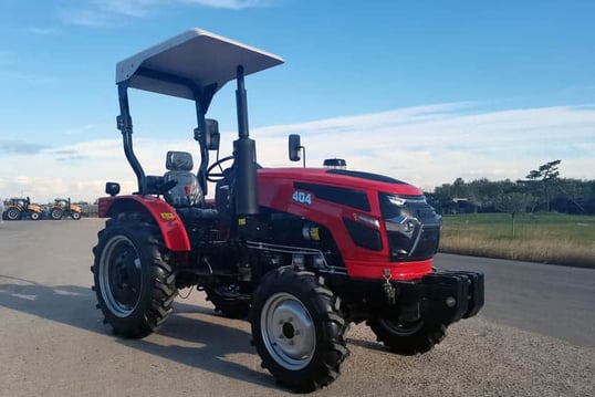a red 40HP/4wd tractor with a canopy over it