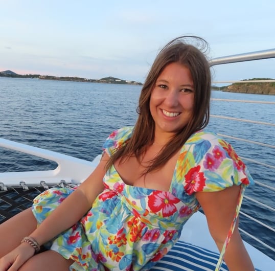 a woman in a floral dress sitting on a boat