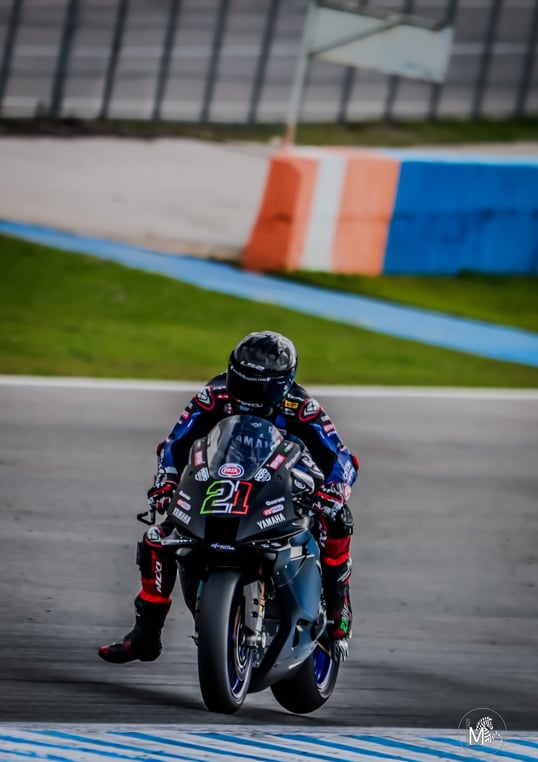 a person riding a motorcycle on a track
