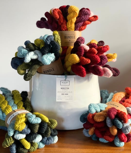 Blue Sky Fibers Warm and Cool Bundles of mini yarn hanks in a white vase arranged like a bouquet