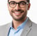 a smiling man in a suit and glasses